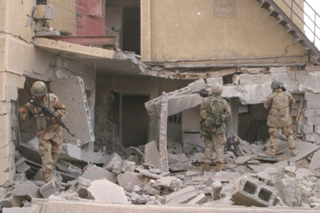 U.S. Marines and Iraqi Armed Forces soldiers clear buildings during Operation al Fajr (New Dawn) in Fallujah, Iraq, on Dec. 11, 2004. Al Fajr is an offensive operation to eradicate enemy forces within the city of Fallujah in support of continuing security and stabilization operations in the Al Anbar province of Iraq by units of the 1st Marine Division. 