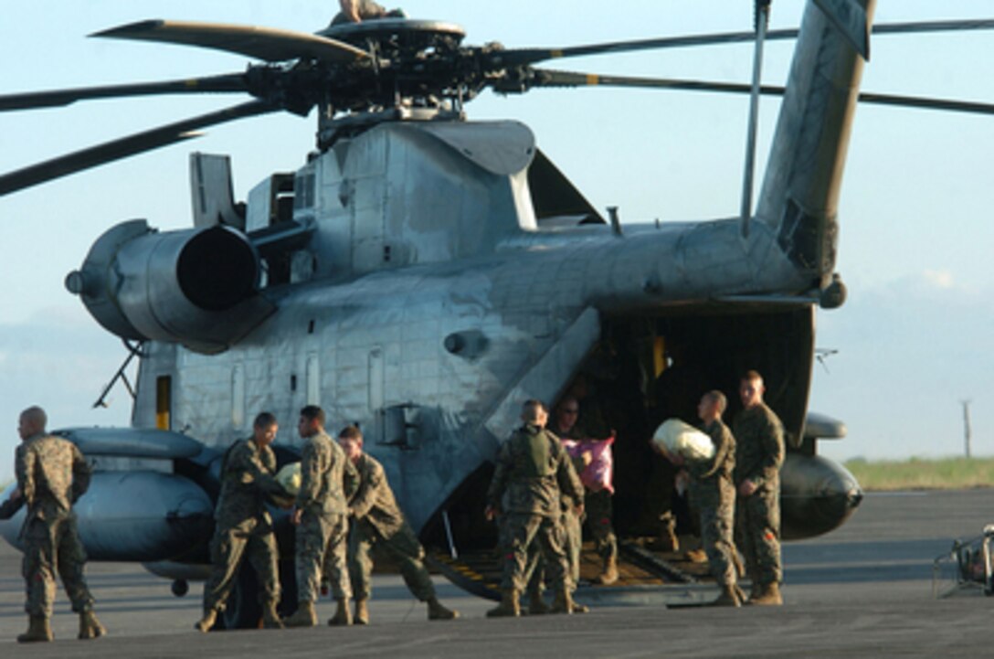 U.S. Marines load a CH-53D Super Stallion helicopter with sacks of rice, flour and canned goods at Clark Airfield, Philippines, during typhoon relief operations on Dec. 13, 2004. Approximately 600 U.S. service members are in the Philippines providing humanitarian assistance and disaster relief to residents of the Quezon Province. U.S. Air Force and Marine Corps helicopters are flying daily missions to provide relief to the stricken areas. The Super Stallion is assigned to Marine Heavy Helicopter Squadron 463 from Kaneohe Bay, Hawaii. 