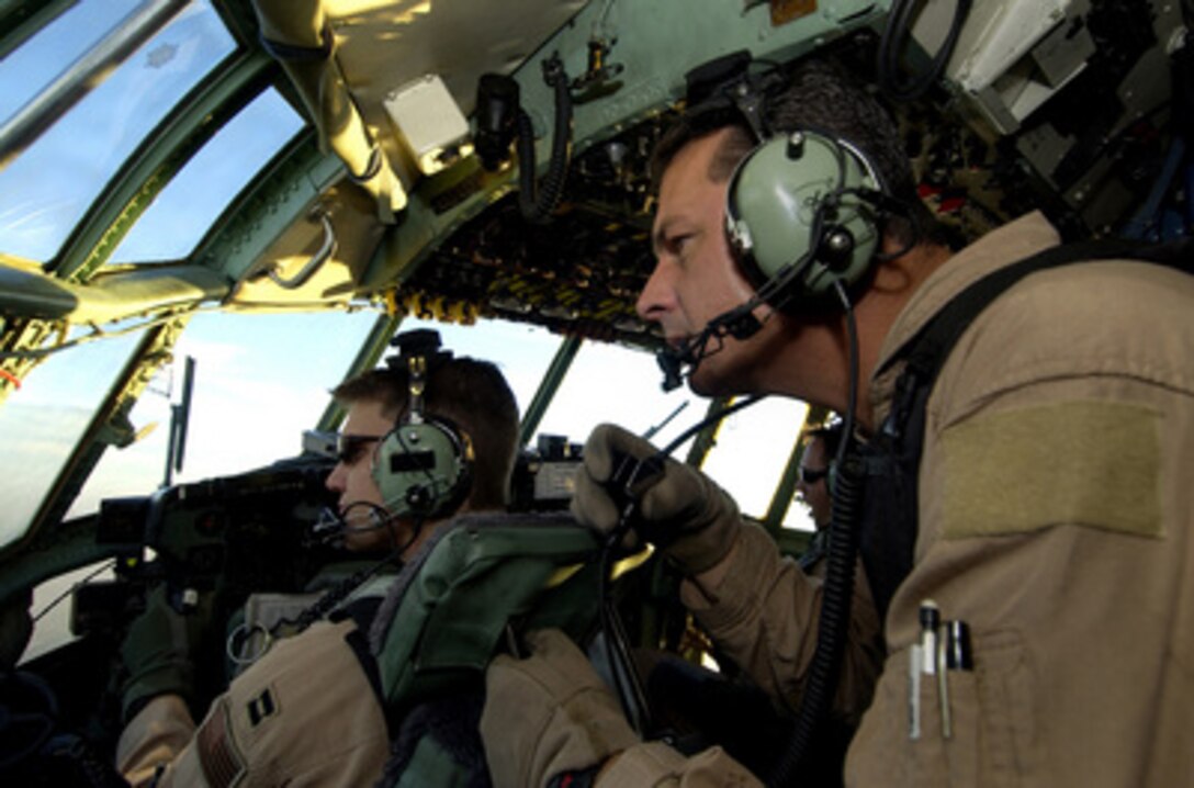 Aircrew members of a C-130 Hercules conduct flight operations during a combat mission on Dec. 4, 2004. The C-130's of the 379th Air Expeditionary Wing are supporting both Operation Iraqi Freedom and Operation Enduring Freedom from a forward deployed location in Southwest Asia. 