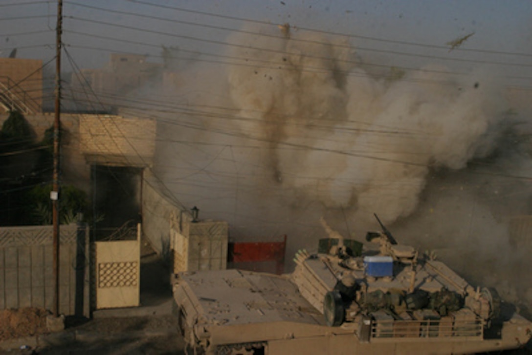 A U.S. Marine Corps M1A1 Abrams tank fires into a building that Marines had received fire from during a firefight in Fallujah, Iraq, in support of Operation al Fajr (New Dawn) on Dec. 10, 2004. Operation al Fajr is an offensive operation to eradicate enemy forces within the city of Fallujah in support of continuing security and stabilization operations in the Al Anbar province of Iraq by units of the 1st Marine Division. The M1A1 is assigned to the 2nd Tank Battalion. 