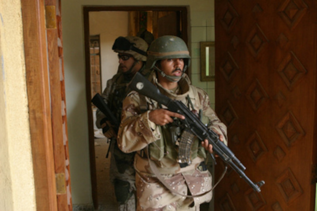 Iraq Armed Forces soldiers and U.S. Marines clear buildings in Fallujah, Iraq, in support of Operation al Fajr (New Dawn) on Dec. 10, 2004. Operation al Fajr is an offensive operation to eradicate enemy forces within the city of Fallujah in support of continuing security and stabilization operations in the Al Anbar province of Iraq. The Marines are assigned to 3rd Platoon, I Company, 3rd Battalion, 5th Marine Regiment, 1st Marine Division. 