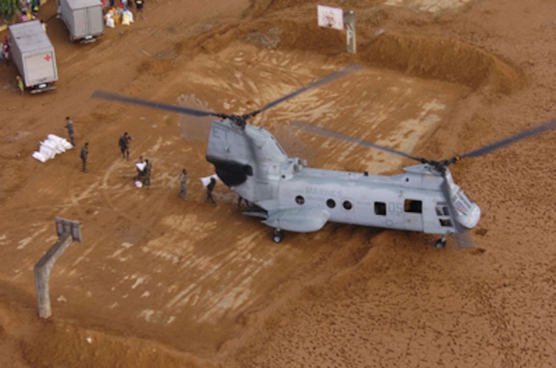 A U.S. Marine Corps CH-46E Sea Knight helicopter delivers relief supplies to Infanta City in the Quezon Province of the Philippines during disaster relief operations on Dec. 14, 2004. About 600 U.S. military personnel are in the Philippines providing humanitarian assistance to residents of Quezon Province where widespread flooding and landslides have occurred. U.S. Marine and Air Force helicopters are flying daily relief missions to the stricken areas. The Sea Knight is assigned to Helicopter Medium Squadron 262 from Marine Corps Air Station Futenma, Okinawa, Japan. 