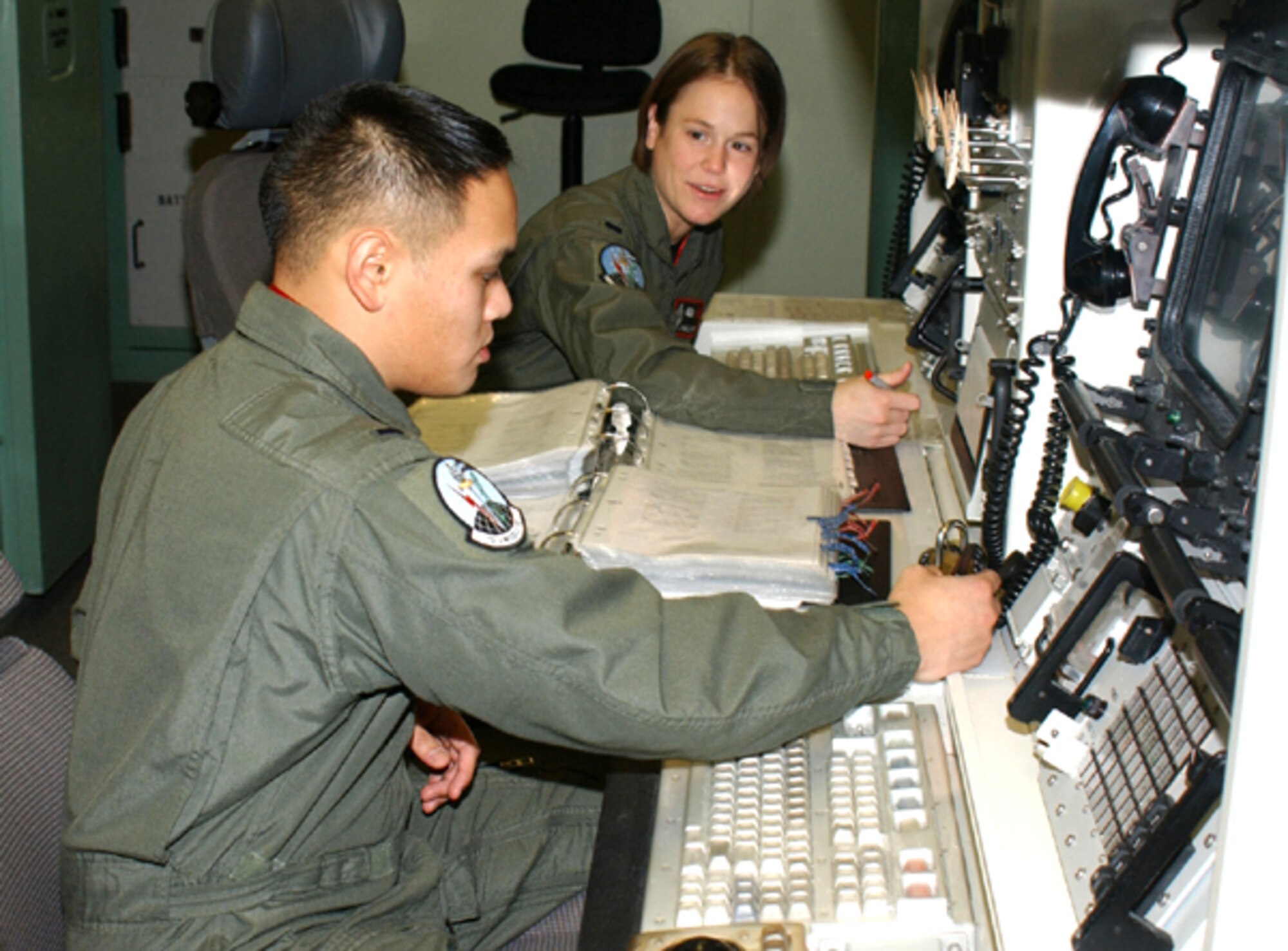 MALMSTROM AIR FORCE BASE, Mont. -- First Lts. Janelle Rust (rear) and Johann Peralta are missile officers assigned to the 12th Missile Squadron here.  Lieutenant Rust donated bone marrow to a 3-year-old girl and said she now plans to coordinate an awareness drive here for the donation program.  (Courtesy photo)