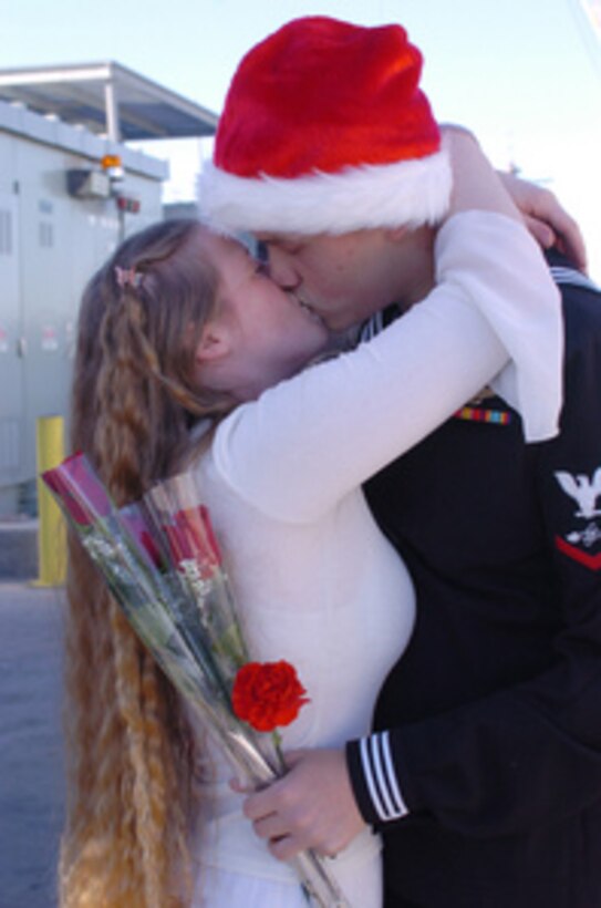 Petty Officer 3rd class Danier Haarliammert kisses his girlfriend Jennifer Filson after returning to San Diego, Calif., aboard the USS Preble (DDG 88) on Dec. 17, 2004. The destroyer Preble was one of several U.S. Navy, Coast Guard and coalition ships that shared the responsibility of patrolling and safeguarding the waters near the Khawr AL Amaya and Al Basrah oil terminals in the northern Persian Gulf. Haarliammert is a Navy aviation electronics technician. 