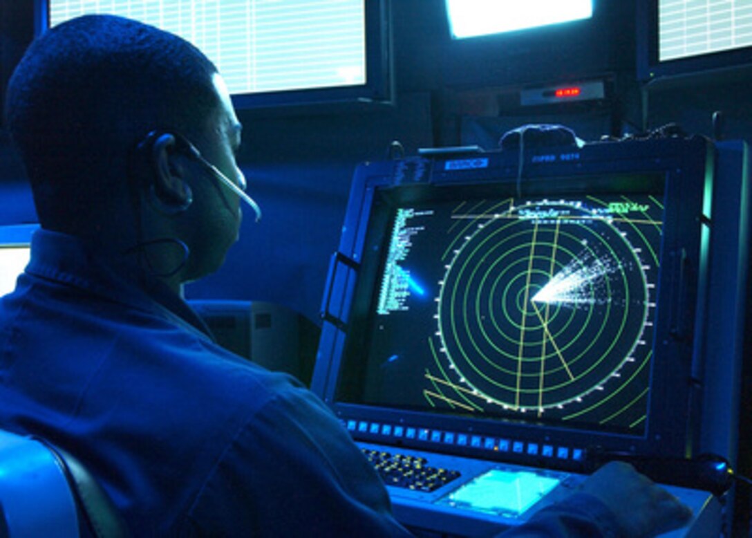 Navy Petty Officer 3d class Corey Fowler controls inbound aircraft during flight operations aboard the aircraft carrier USS Theodore Roosevelt (CVN 71) on Dec. 13, 2004. Roosevelt is on deployment conducting sea trials in the Atlantic Ocean. Fowler is a Navy air traffic controller. 