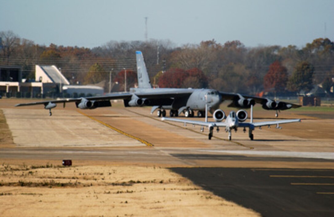 A U.S. Air Force B-52H Stratofortress taxies onto the runway behind an A-10A Thunderbolt II at Barksdale Air Force Base, La., on Dec. 15, 2004. The aircraft are taking part in a 3-day local competition known as Buffsmoke and involves aircrews, maintenance and support personnel. The Stratofortress is assigned to the 2nd Bomb Wing's 20th Bomb Squadron and the Thunderbolt to the Air Force Reserve 917th Wing. 
