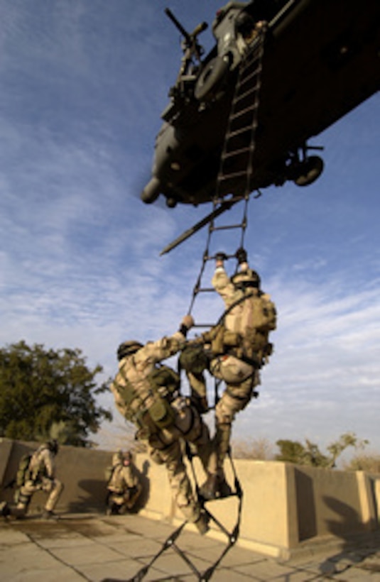 U.S. Air Force Para-rescuemen from the 64th Expeditionary Rescue Squadron are extracted by an HH-60G Pave Hawk helicopter from an abandoned housing site near the Baghdad International Airport, Iraq, on Dec. 20, 2004. 