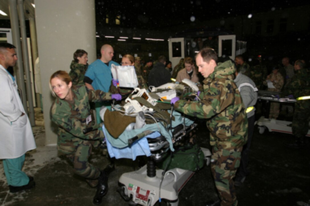 Medical personnel at Landstuhl Regional Medical Center in Landstuhl, Germany, rush a wounded U.S. soldier from an ambulance into the hospital on Dec. 22, 2004. The soldier was wounded during the December 21st attack at a dining facility in Mosul, Iraq. 