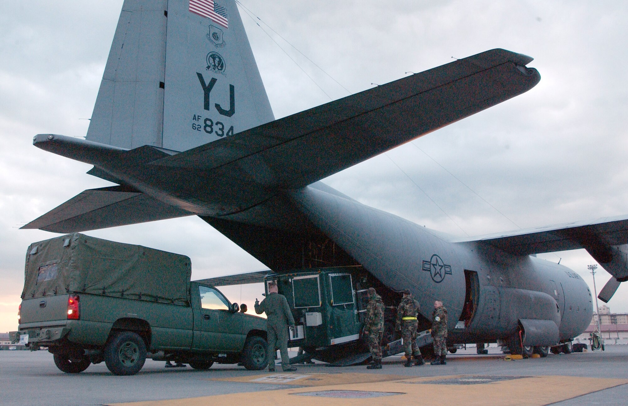 YOKOTA AIR BASE, Japan -- Airmen from here load a C-130 Hercules with mission-support materials Dec. 28.  The Airmen are deploying to Thailand supporting relief efforts after an earthquake and tsunamis devastated coastal regions of the Indian Ocean on Dec. 26.  They will help establish a forward-operating base and assess the needs for additional relief efforts in the region.  (U.S. Air Force photo by Airman 1st Class Katie Thomas)