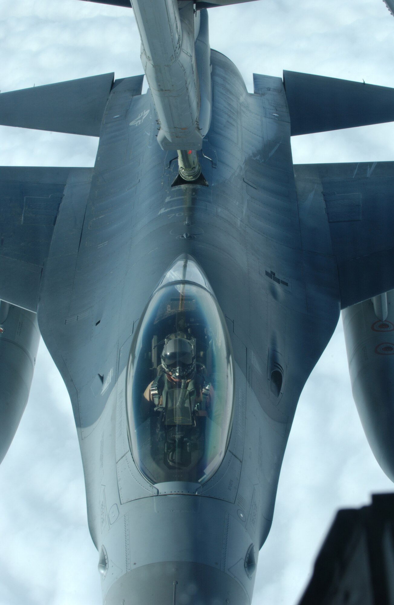 OVER IRAQ -- An F-16 Fighting Falcon receives fuel from a KC-10A Extender during a combat patrol Dec. 25.  The tanker is assigned to the 908th Expeditionary Aerial Refueling Squadron.  (U.S. Air Force photo by Senior Master Sgt. Mark Moss)