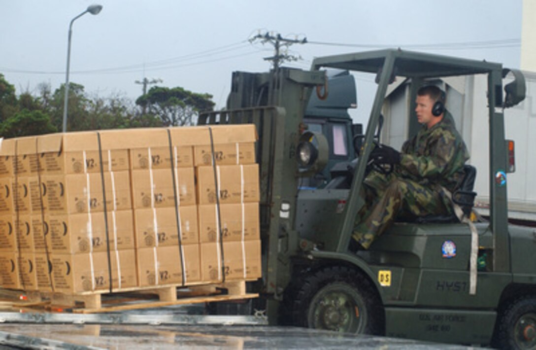 U.S. Air Force Tech. Sgt. Justin Sturn positions 48 cases of Meals Ready to Eat on an aircraft pallet at Kadena Air Base, Japan, on Dec. 28, 2004. The meals will be flown to Southeast Asia as part of disaster relief following an earthquake that caused tsunami waves that affected 12 countries. Sturn is assigned to the 733rd Air Mobility Squadron, 18th Air Wing. 