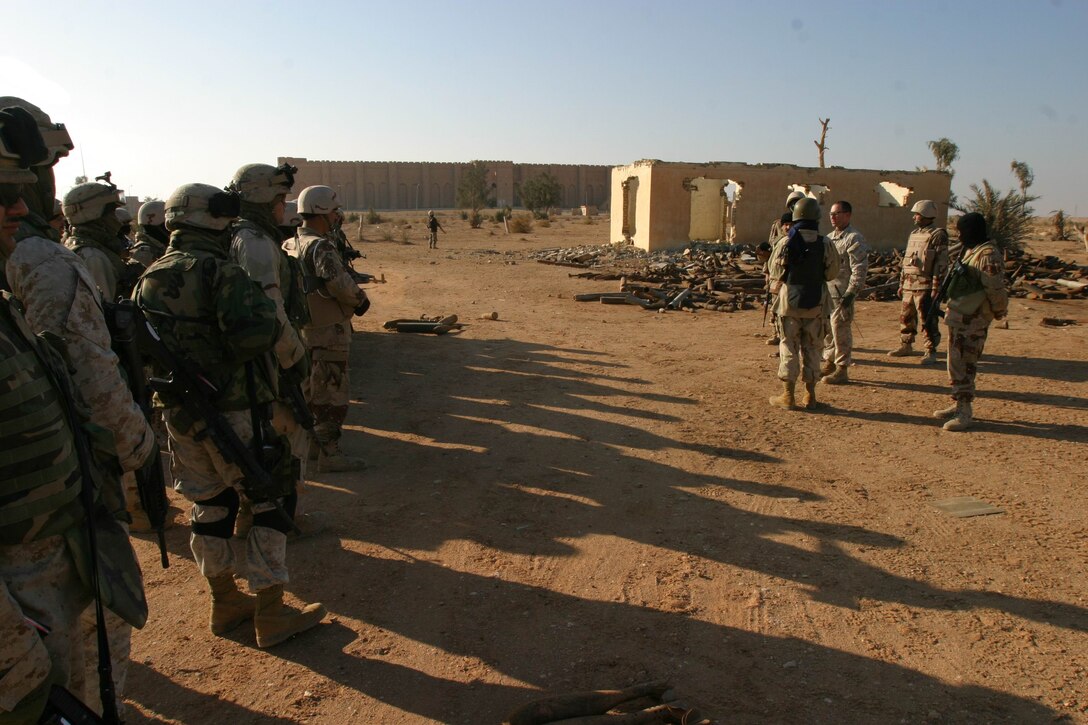 Master Sgt. Michael W. Snow, Explosive Ordnance Disposal chief, Marine Expeditionary Unit Service Support Group 11, 11th MEU (Special Operations Capable), gives a safety brief to Iraqi National Guard soldiers and MEU Marines before an unexploded ordnance cleanup operation near a 1,200 year-old medieval Persian fort, Dec. 29.