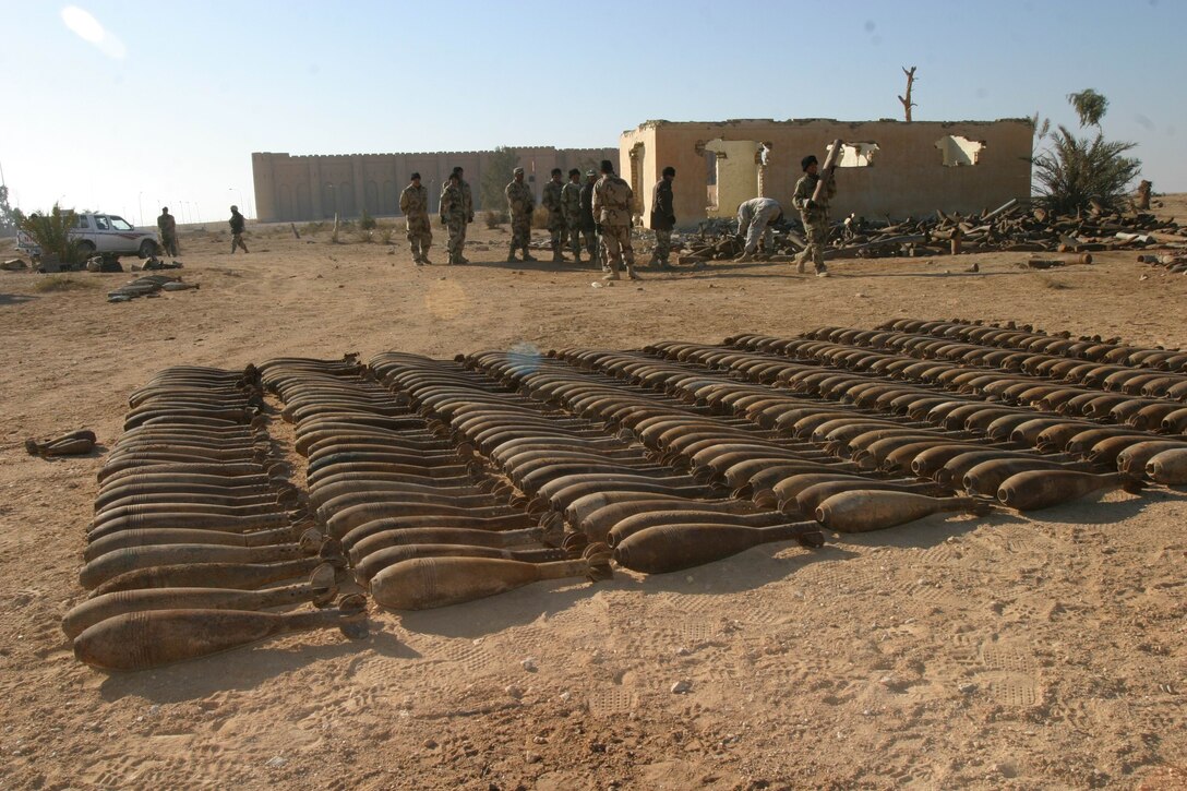 More than 500 120 millimeter white phosphorous mortar rounds are set in neat, orderly rows by Marines from Weapons Platoon, Company A, Battalion Landing Team 1st Battalion, 4th Marine Regiment, 11th Marine Expeditionary Unit (Special Operations Capable), and soldiers from Company A, 401st Battalion, 51st Iraqi National Guard Brigade, during an unexploded ordnance cleanup operation near Al Ukhidhir Fort, Iraq, Dec. 29.