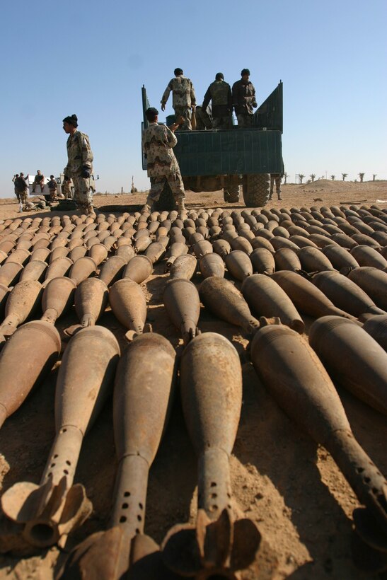 Soldiers from Company A, 401st Battalion, 51st Iraqi National Guard Brigade, load hundreds of 120 millimeter white phosphorous mortar rounds onto an ING truck during an unexploded ordnance cleanup operation near Al Ukhidhir Fort, Iraq, Dec. 29.