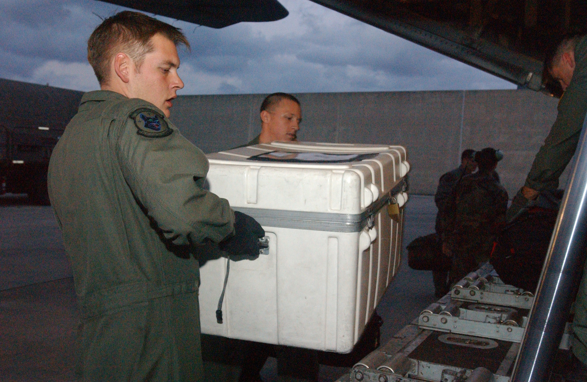 KADENA AIR BASE, Japan -- Airmen here help load relief supplies on an aircraft bound for Southeast Asia as part of disaster relief following a 9.0-magnitude earthquake that struck Dec. 26 off the coast of Indonesia.  The quake caused tsunami waves that have affected 12 countries and have killed more than 100,000 people.  More than 3,000 cases of packaged meals and four aircraft pallets of fresh water were processed through the cargo area here Dec. 29.  The 18th Wing is providing relief supplies and personnel to help with the humanitarian effort.  (U.S. Air Force photo by Tech. Sgt. Richard Freeland)

