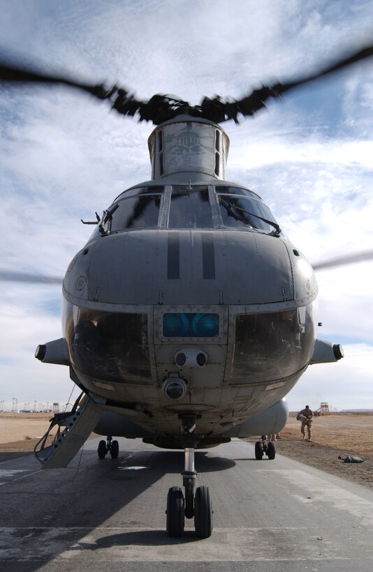 A CH-46E Sea Knight from Marine Medium Helicopter Squadron 365, Marine Aircraft Group 16, 3rd Marine Aircraft Wing, spins on the ground while waiting for its passengers to arrive Dec. 30. The mission for the day was transporting troops from Al Asad, Iraq to a forward operating base near the Syrian border and back again. The squadron transports troops and cargo throughout the Al Anbar province of Iraq daily.