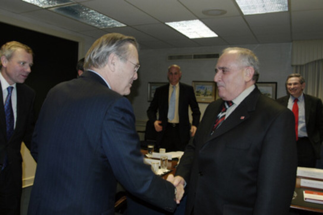 Secretary of Defense Donald H. Rumsfeld greets Turkish Minister of National Defense Vecdi Gonul during his meeting with Deputy Secretary of Defense Paul Wolfowitz (far right) on Jan. 29, 2004, in the Pentagon. Rumsfeld had just completed his meeting with NATO Secretary General Jaap de Hoop Scheffer (far left) and the two leaders stopped by for a courtesy call on Gonul. 