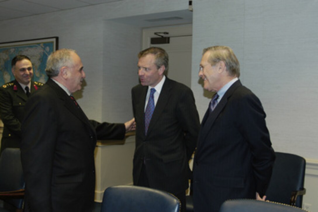 Turkish Minister of National Defense Vecdi Gonul (left) receives a courtesy call from NATO Secretary General Jaap de Hoop Scheffer (center) and Secretary of Defense Donald H. Rumsfeld (right). Gonul was meeting with Deputy Secretary of Defense Paul Wolfowitz when Scheffer and Rumsfeld stopped by after their meeting on Jan. 29, 2004, in the Pentagon. 