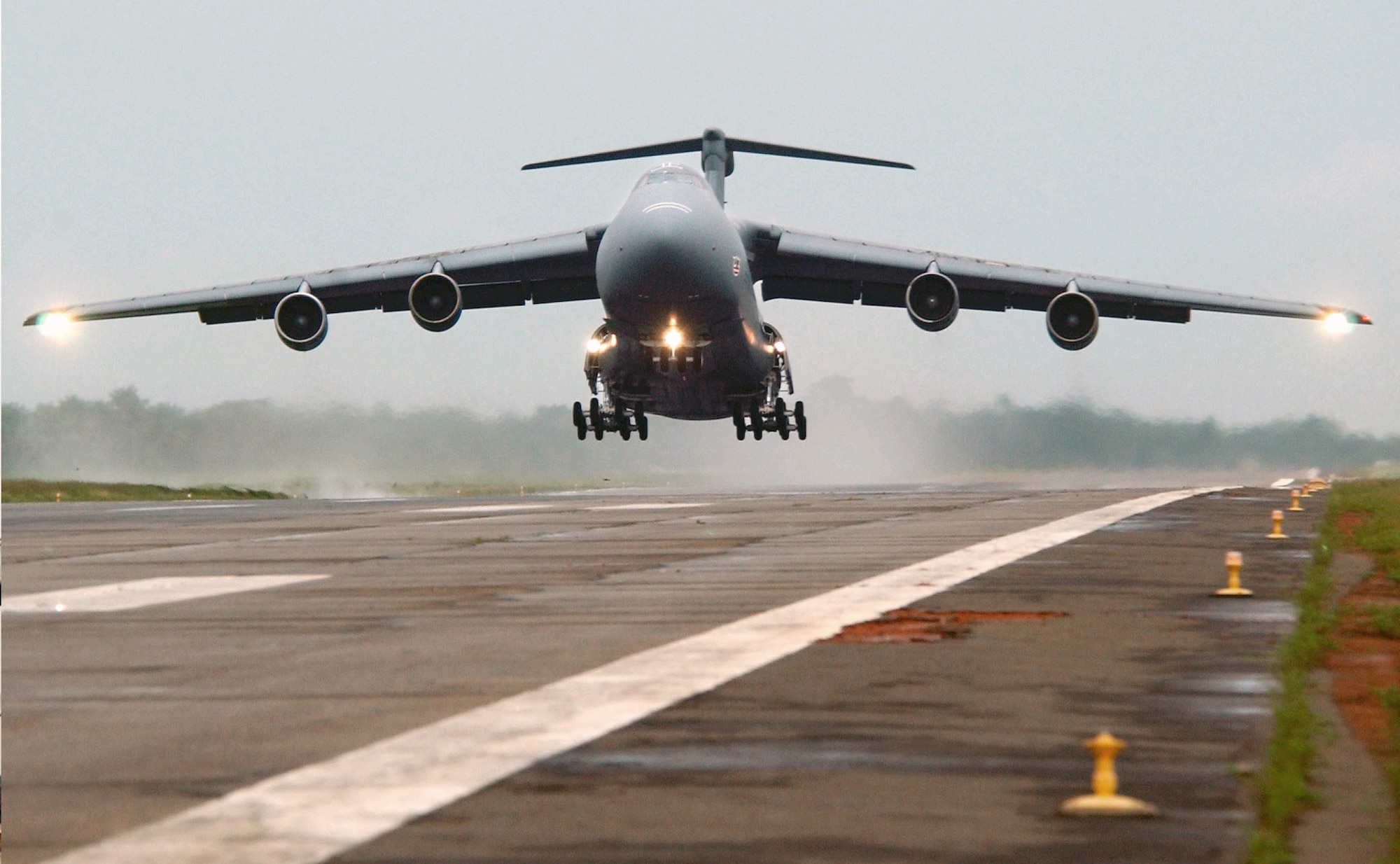 SOUTHWEST ASIA -- A C-5 Galaxy takes off from an airfield at a forward-deployed location.  By using a newly developed grease on the C-5, the Air Force could solve several challenges related to wear, corrosion and rust in the landing gear assembly of the aircraft.  (U.S. Air Force photo by Tech. Sgt. Justin D. Pyle)