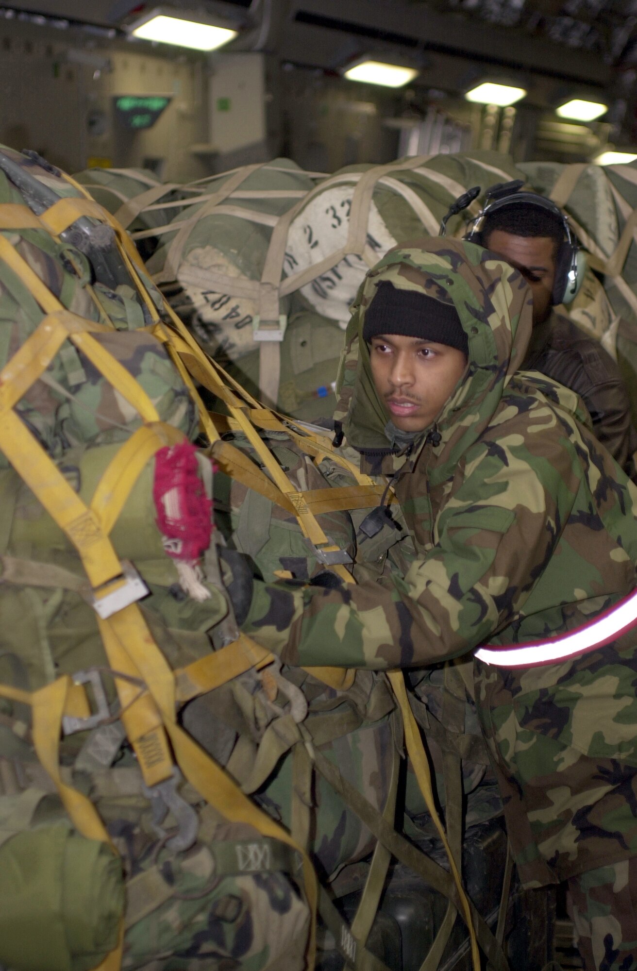 INCIRLIK AIR BASE, Turkey -- Staff Sgt. Nolan Jones pushes pallets off a C-17 Globemaster III here.  Sergeant Jones is assigned to the 728th Air Mobility Squadron's aircraft services team.  (Photo by Airman 1st Class Joseph Thompson)