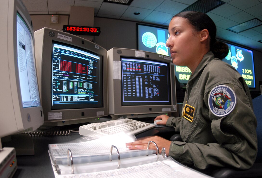 SCHRIEVER AIR FORCE BASE, Colo. -- Senior Airman Nayibe Ramos runs through a checklist during Global Positioning System satellite operations.  The operations center here controls a constellation of 29 orbiting satellites that provides navigation data to military and civilian users worldwide.  Airman Ramos is a satellite system operator for the 2nd Space Operations Squadron here.  (U.S. Air Force photo by Airman 1st Class Mike Meares)