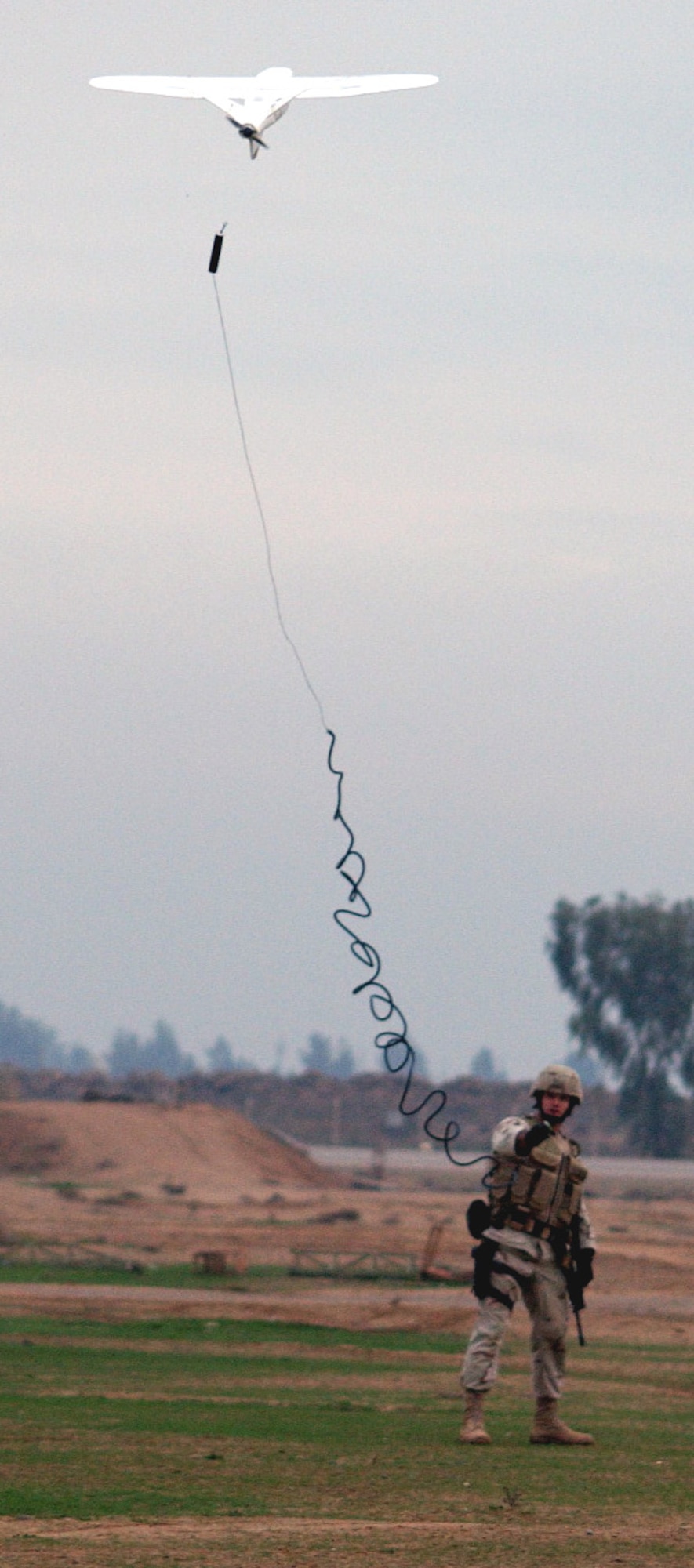 BALAD AIR BASE, Iraq (AFPN) -- Desert Hawk launches as Senior Airman David Tillery, stands fast.  The 7-pound unmanned aerial vehicle allows security forces to see beyond a base's perimeters and provide accurate, real-time visual assessments of detected threats.  Airman Tillery is assigned to the 332nd Expeditionary Security Forces Squadron and is deployed from Shaw Air Force Base, S.C.  (U.S. Air Force photo by Staff Sgt. A.C. Eggman)