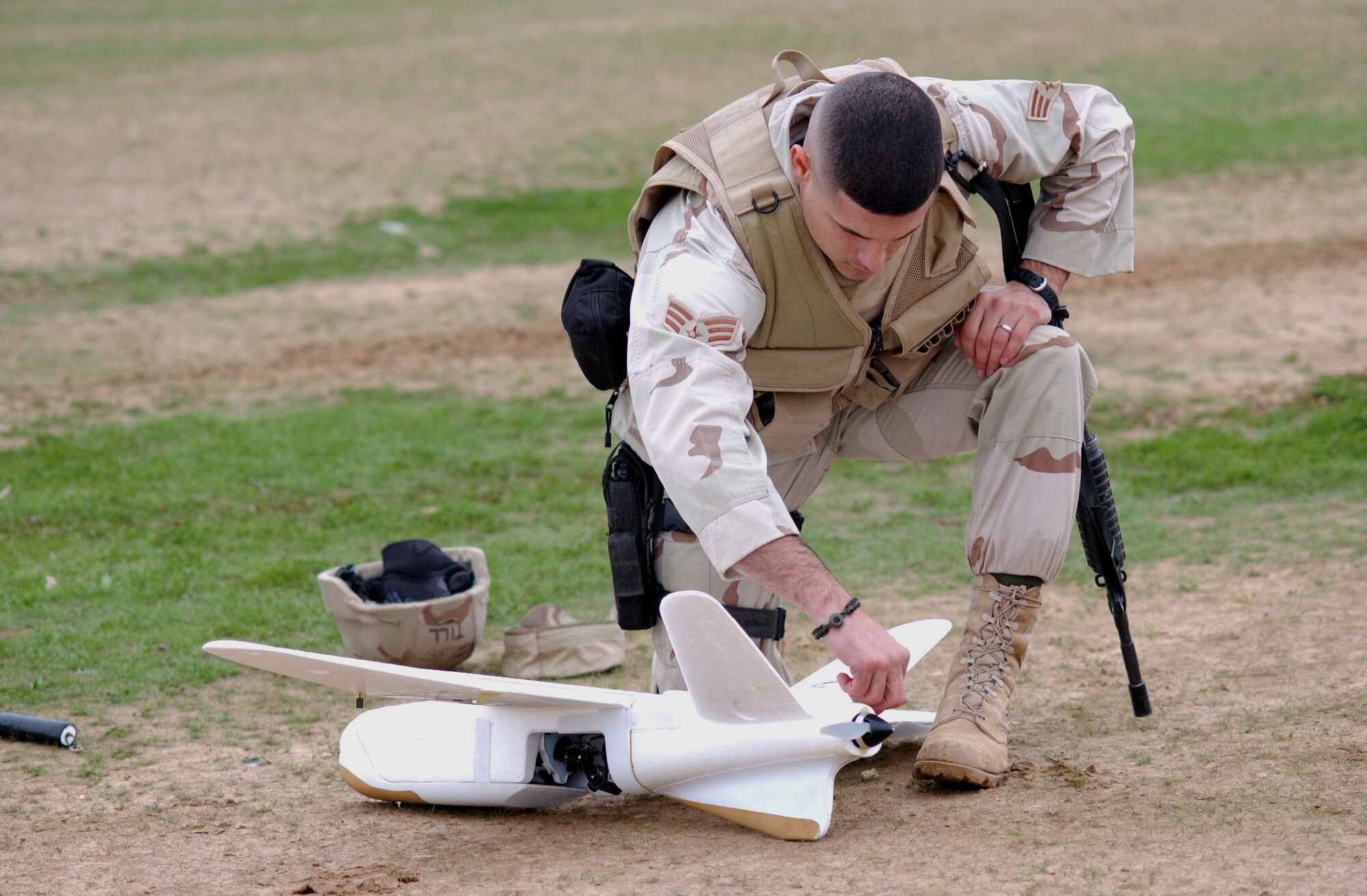 BALAD AIR BASE, Iraq (AFPN) -- Senior Airman David Tillery aligns the Desert Hawk control surfaces before a launch.  The 7-pound unmanned aerial vehicle allows security forces to see beyond a base's perimeters and provide accurate, real-time visual assessments of detected threats.  Airman Tillery is assigned to the 332nd Expeditionary Security Forces Squadron and is deployed from Shaw Air Force Base, S.C.  (U.S. Air Force photo by Staff Sgt. A.C. Eggman)