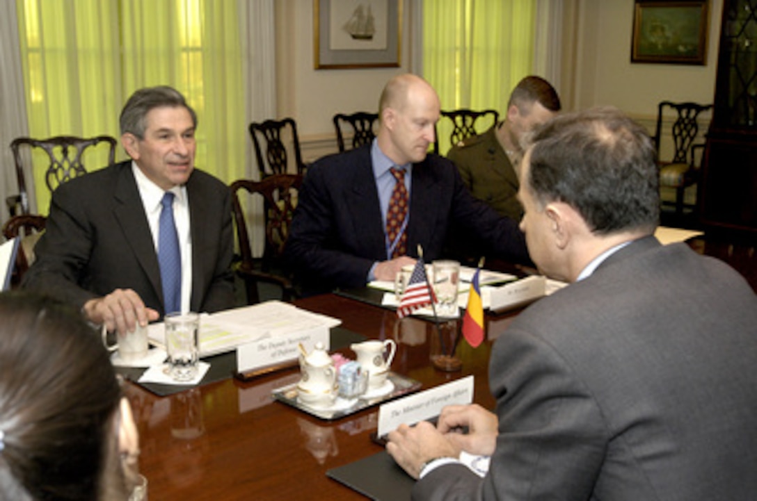 Deputy Secretary of Defense Paul Wolfowitz (left) hosts a meeting with Romanian Minister of Foreign Affairs Mircea Geoana (foreground) in the Pentagon on Feb. 4, 2004. Under discussion is a broad range of bilateral security issues. Also participating in the talks on the U.S. side are Deputy Assistant Secretary of Defense for European and NATO Affairs Ian Brzezinski (center) and Col. Steve Ganyard, U.S. Marine Corps, military assistant to the Deputy Secretary of Defense. 