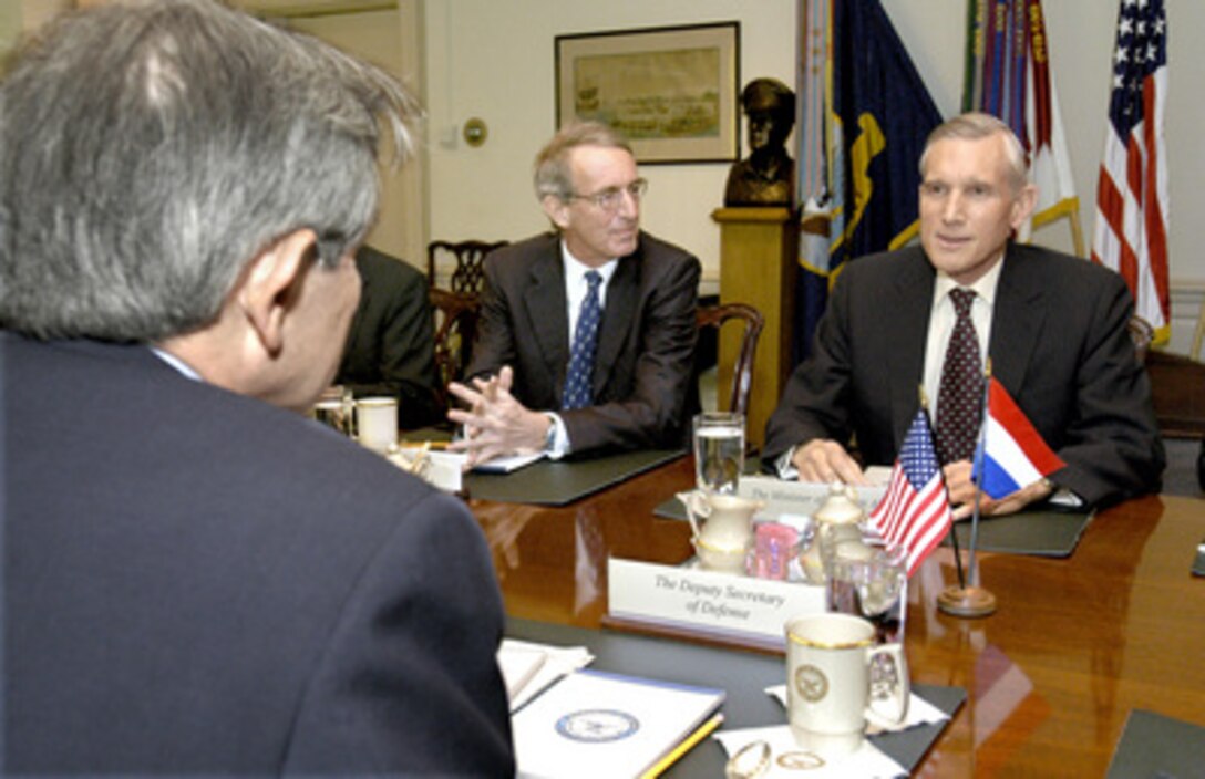 Netherlands' Minister of Foreign Affairs Bernard Bot (right) meets in the Pentagon with Deputy Secretary of Defense Paul Wolfowitz (foreground) on Feb. 9, 2004. A wide range of security issues of mutual interest was on the table for discussion. Also participating in the talks is the Netherlands' Ambassador to the United States Boudewijn van Eenennaam (center). 