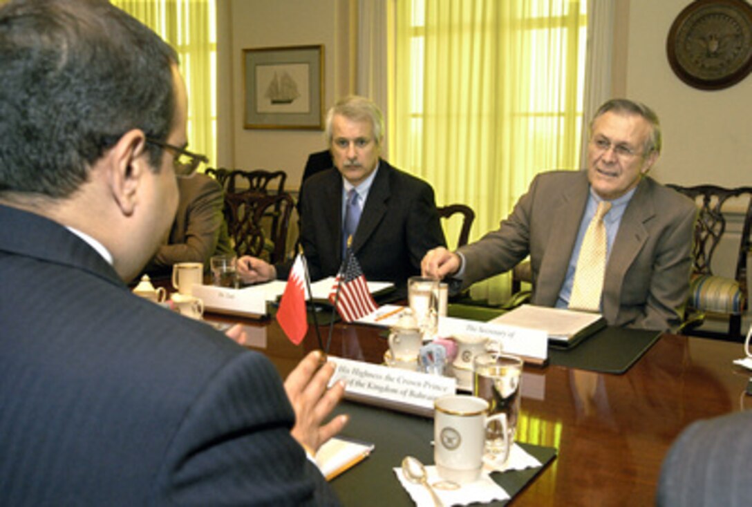 Secretary of Defense Donald H. Rumsfeld (right) hosts a meeting with Bahrain's Crown Prince Salman bin Hamad Al-Khalifa (foreground) in the Pentagon on Feb. 11, 2004. The two defense leaders are meeting to discuss a range of issues from military equipment procurement to regional security concerns. Also participating in the talks is Deputy Assistant Secretary of Defense for Special Plans and Near Eastern and South Asian Affairs William Luti (center). 