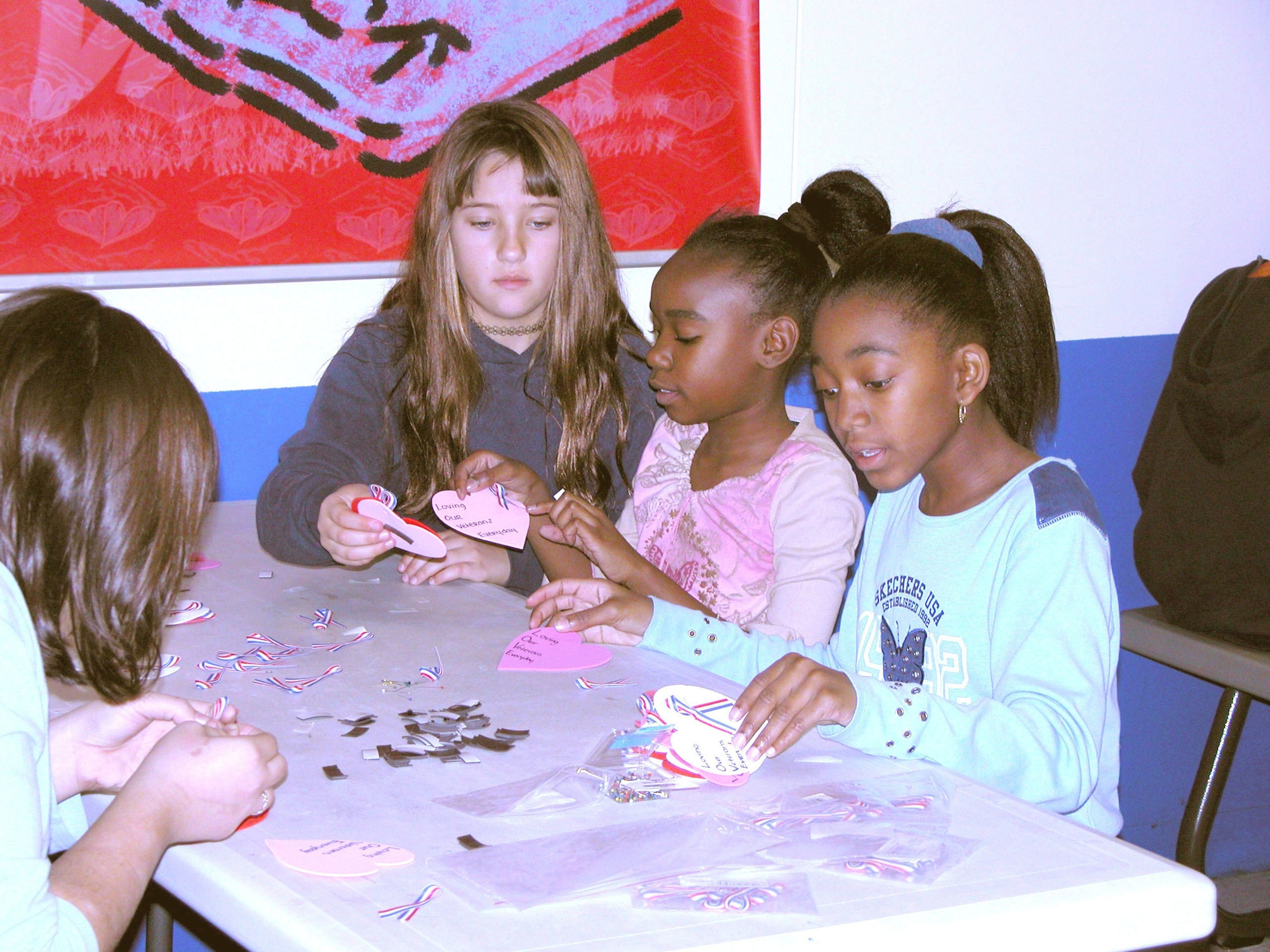 EGLIN AIR FORCE BASE, Fla. -- Stephanie Alvarez, Alyna Avance and Jazmyn Jordan assemble valentines at the youth center here to prepare for this year's "Valentines for Vets" program.  (U.S. Air Force photo by Lois Walsh)