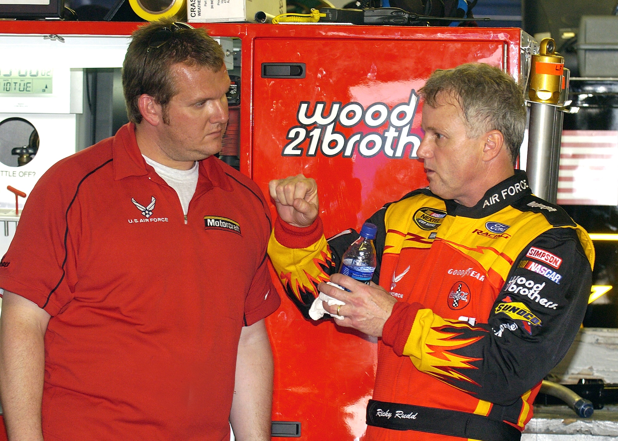 DAYTONA INTERNATIONAL SPEEDWAY, Fla. -- Ricky Rudd, driver of the Air Force-sponsored Wood Brothers Racing No. 21 Ford Taurus goes over some car-handling details with his crew chief, Ben Leslie, following a practice session at the speedway Feb. 11.  They are preparing for the Daytona 500 race, which will be held here Feb. 15.  (U.S. Air Force photo by Larry McTighe)