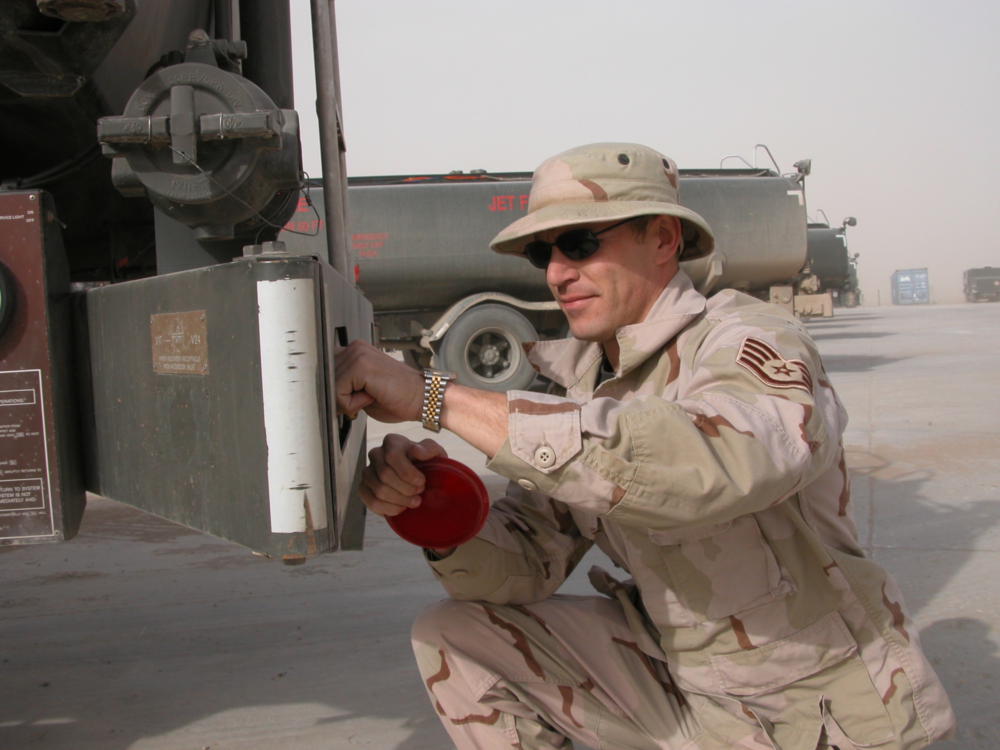 TALLIL AIR BASE, Iraq (AFPN) -- Staff Sgt. Luke Salkeld replaces a brake light on an R-11 refueling truck.  The sergeant is the noncommissioned officer in charge of fuels preventive maintenance for the 407th Expeditionary Logistics Readiness Squadron's fuels flight.  He is deployed here from Shaw Air Force Base, S.C.  (U.S. Air Force photo by Photo by Tech. Sgt. Bob Oldham)