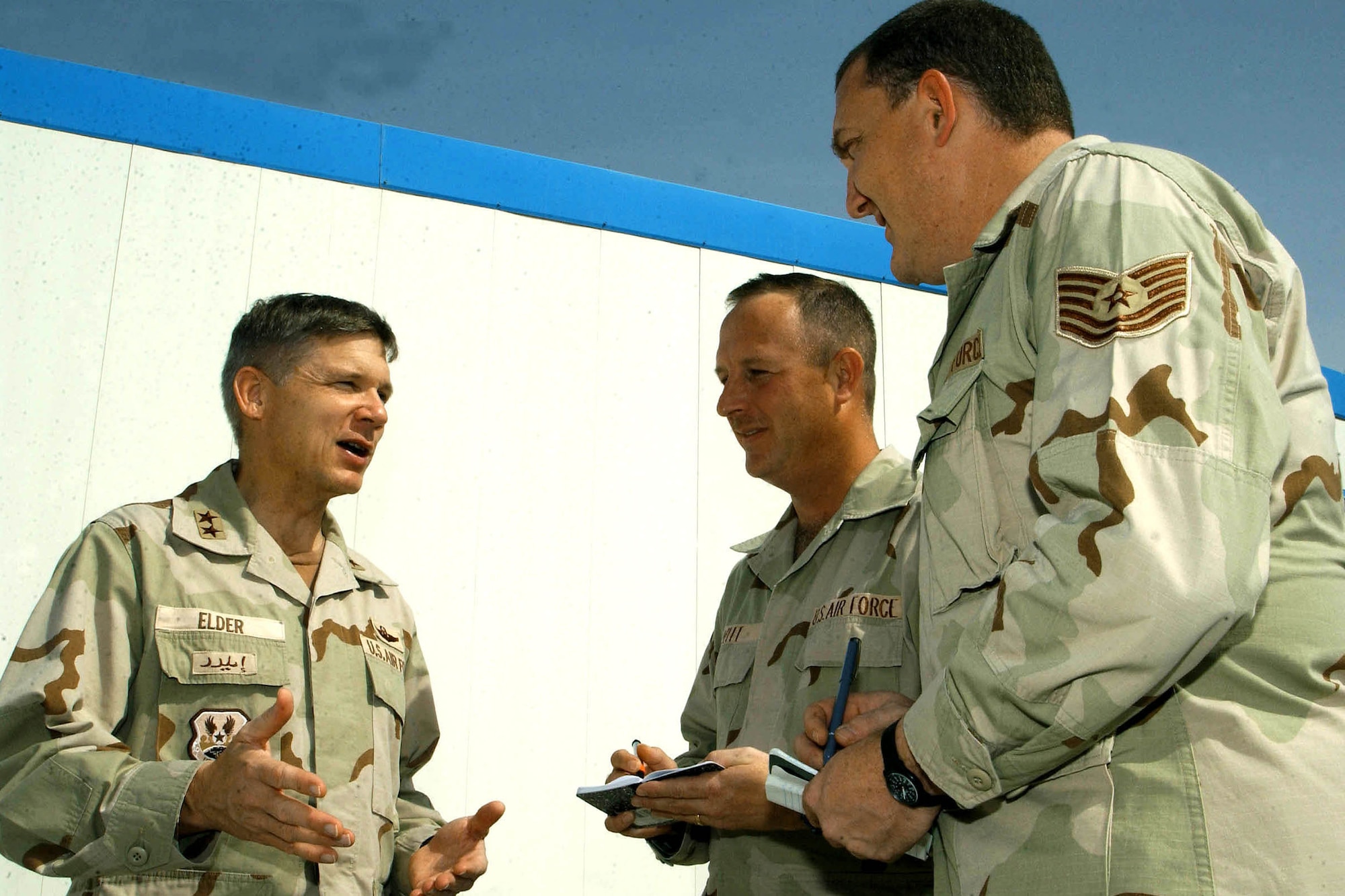 AL UDEID AIR BASE, Qatar -- Maj. Gen. Robert Elder discusses current operations with Master Sgt. Paul Witt and Tech. Sgt. Jason Axberg, historians at the Combined Air Operations Center here.  The historians use interviews to collect and archive information about air operations in the U.S. Central Command area of responsibility.  General Elder is the deputy commander of the Combined Forces Air Component.  (U.S. Air Force photo by Master Sgt. Jeff Bohn)