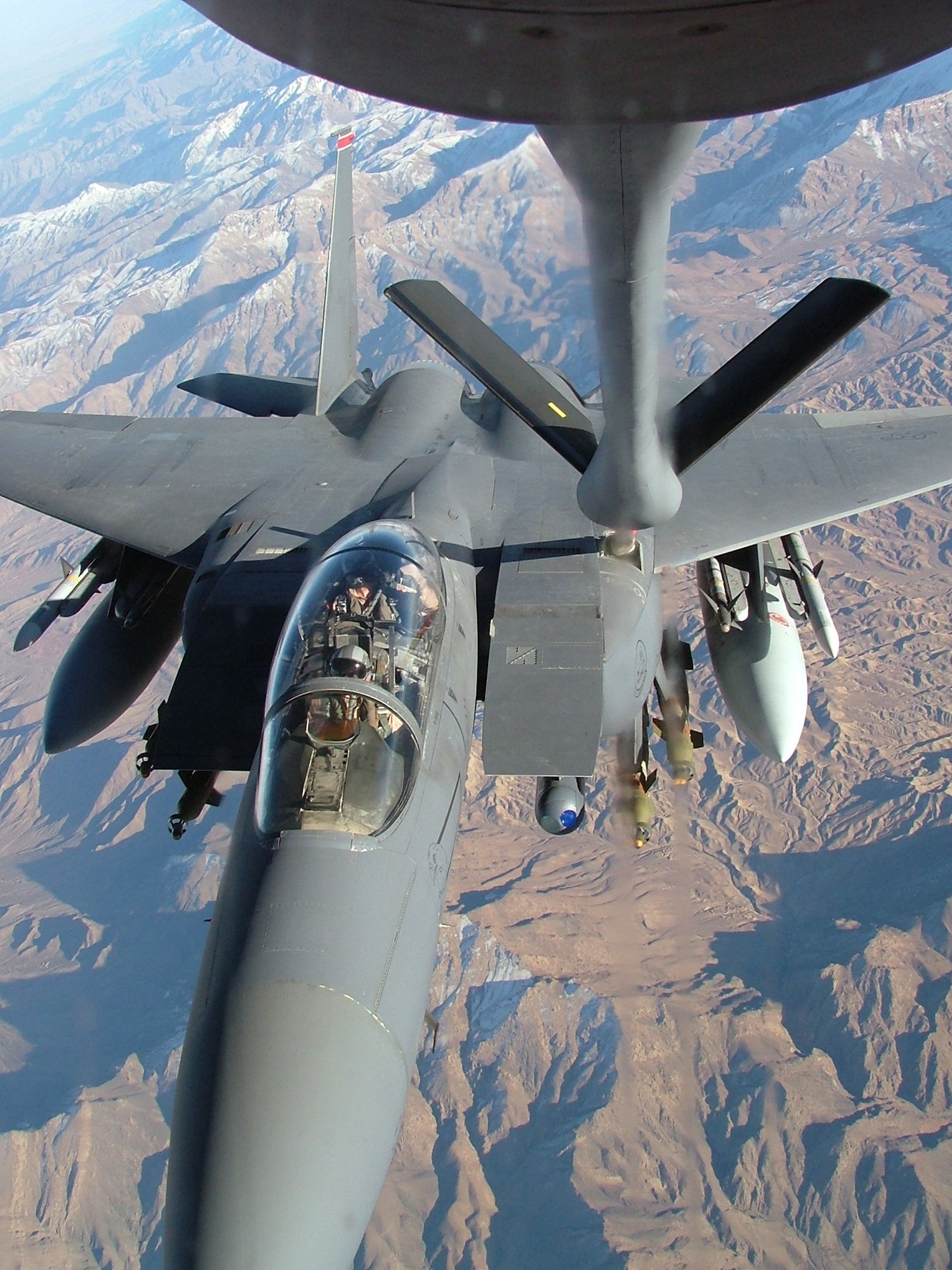MANAS AIR BASE, Kyrgyzstan -- A 22nd Expeditionary Air Refueling Squadron KC-135 Stratotanker refuels an F-15E Strike Eagle over Afghanistan.  (Courtesy photo)