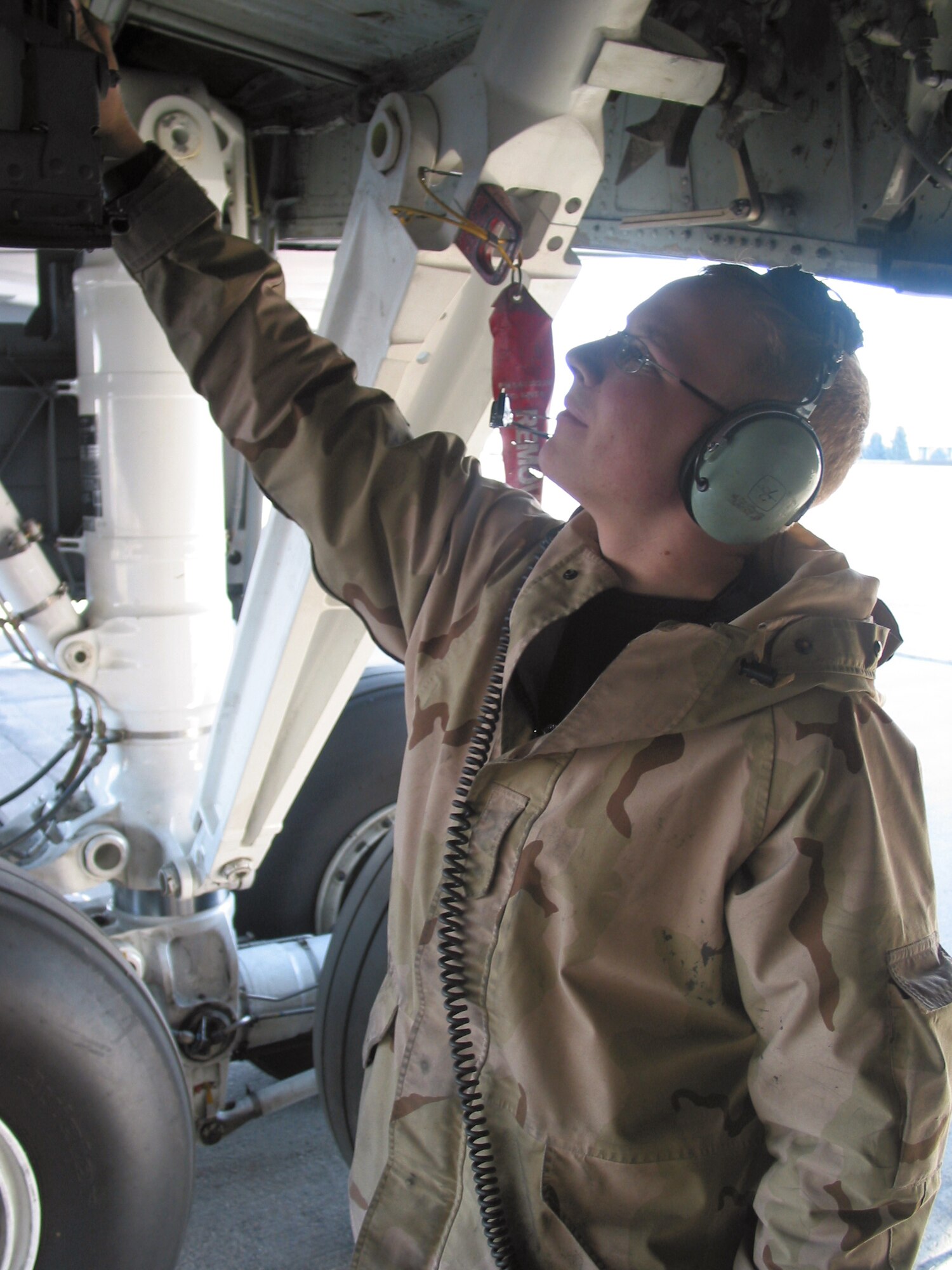 MANAS AIR BASE, Kyrgyzstan -- Senior Airman Micah Ramthun checks the wheel well of a KC-135 Stratotanker.  He is assigned to the 376th Expeditionary Maintenance Squadron.  (U.S. Air Force photo by Capt. Brus E. Vidal)