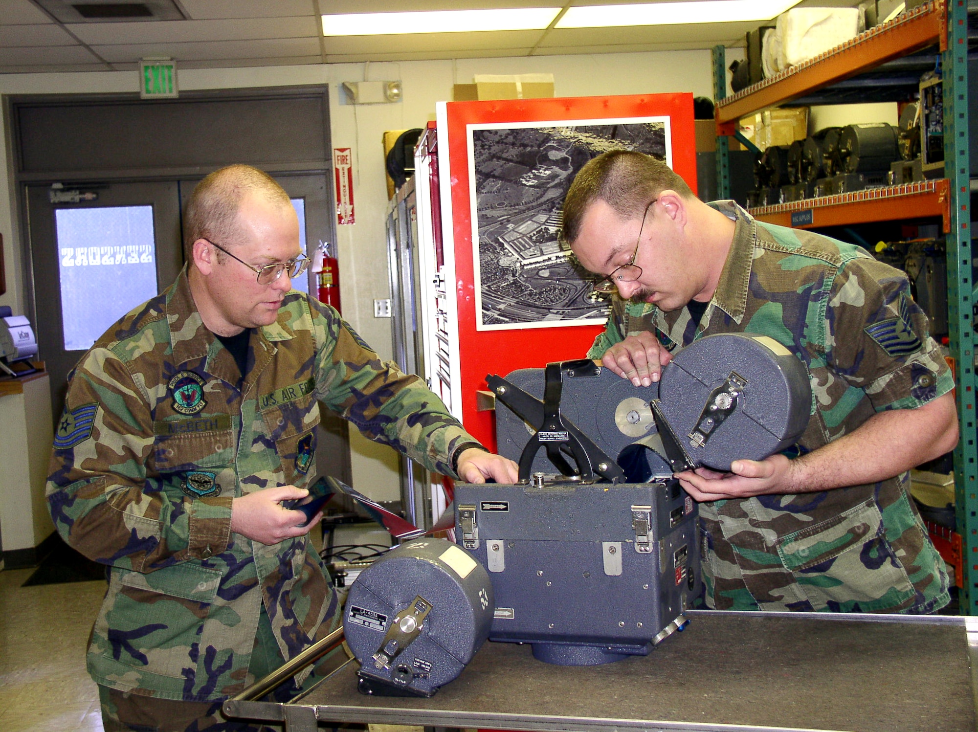 RENO, Nev. -- Tech. Sgts. Brian McBeth (left) and Brian Guettler repair a KS-87B film camera in the avionics shop at the Nevada Air National Guard Base here.  The camera is used in counterdrug aerial reconnaissance operations.  The two sergeants are the last of the KS-87B film camera repairmen in the military.  (U.S. Air Force photo by Staff Sgt. Erick Studenicka)