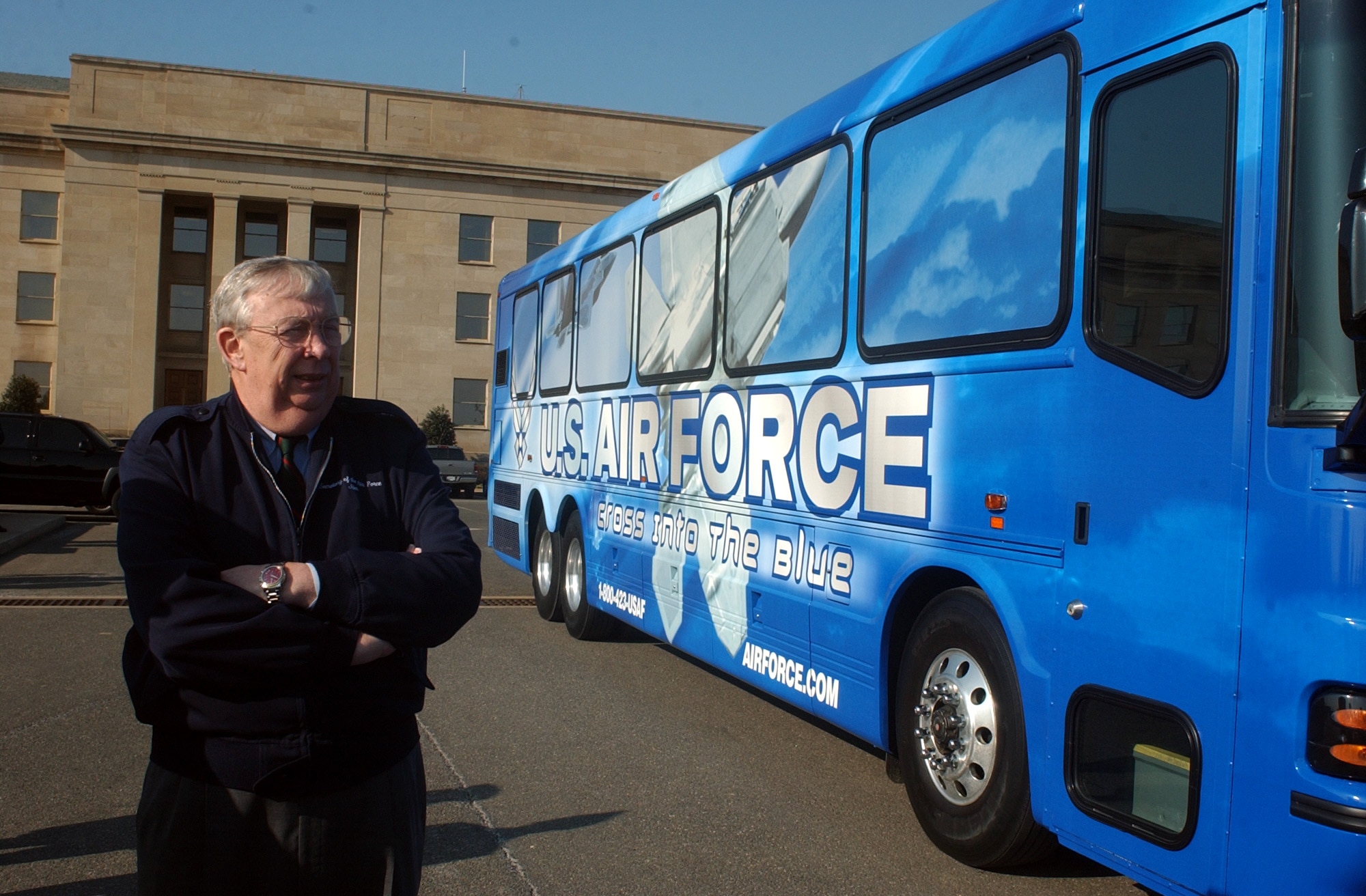 WASHINGTON -- Secretary of the Air Force Dr. James G. Roche inspects the new bus design scheme at the Pentagon on Feb. 19.  The new graphic design on the buses reflects the mission of the Air Force and demonstrates the diversity of careers in today's Air Force.  There are a total of 10 buses in this test program.  Four will operate from Bolling Air Force Base, D.C., and the other six will be at Randolph AFB, Texas; the U.S. Air Force Academy, Colo.; and Nellis AFB, Nev.  (U.S. Air Force photo by Master Sgt. Gary R. Coppage)