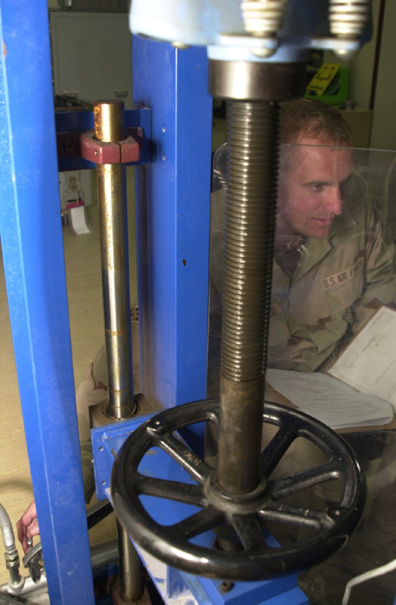 SOUTHWEST ASIA -- Senior Airman Kent Greenwood applies pressure to a portable wheel load scale and a standard scale during calibration.  A portable wheel load scale is commonly used to weigh cargo pallets.  Airman Greenwood is a precision measurement equipment laboratory technician with the 379th Expeditionary Maintenance Squadron and is deployed from Shaw Air Force Base, S.C.  (U.S. Air Force photo by Senior Airman Chawntain Young)