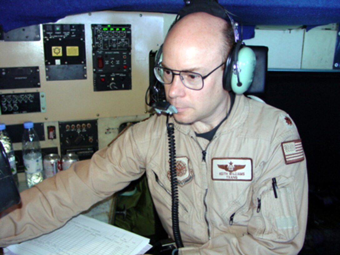 TALLIL AIR BASE, Iraq -- Maj. Keith Williams plots the route his C-130 Hercules is taking during an airlift mission from here to Kuwait.  Major Williams is a navigator with the 328th Expeditionary Airlift Squadron.  (U.S. Air Force photo by Staff Sgt. Chris Stagner)