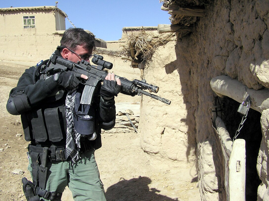 QALAKHEL, Afghanistan -- Special Agent Tony searches for a suspected Taliban weapons cache here.  Agent Tony is a member of the Air Force Office of Special Investigations' anti-terrorism specialty team deployed from Lackland Air Force Base, Texas.  (U.S. Air Force photo by Tech Sgt. Brian Davidson)