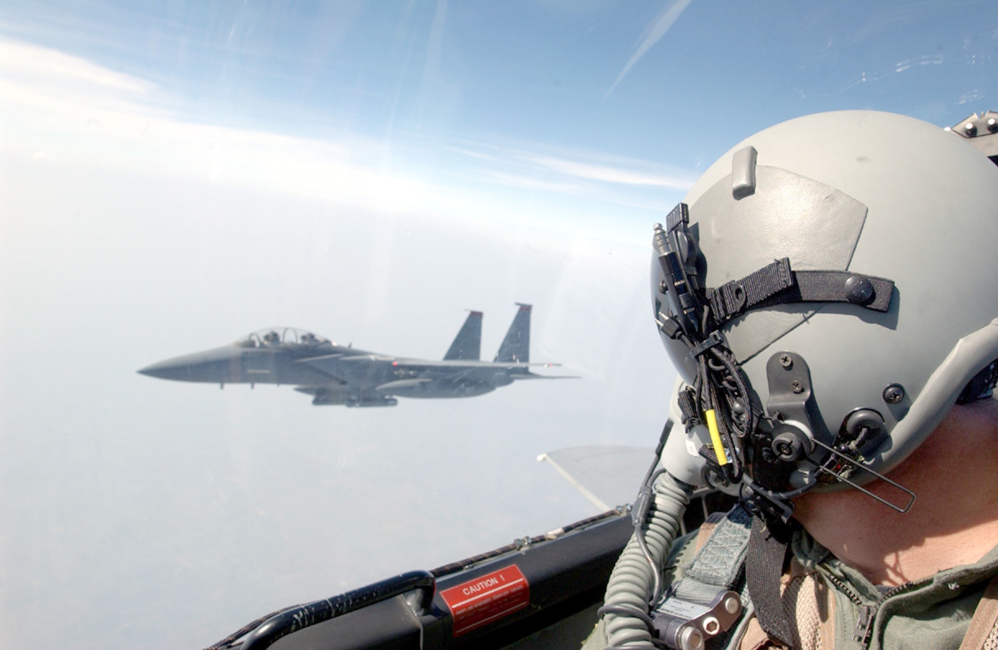 KORAT ROYAL AIR FORCE BASE, Thailand -- An F-15E Strike Eagle crewmember from the 90th Fighter Squadron at Elmendorf Air Force Base, Alaska, checks his wingman during a Cope Tiger '04 exercise mission.  Strike Eagles are participating for the first time in the 10-year history of the exercise.  (U.S. Air Force photo by Tech. Sgt. Lee Harshman)