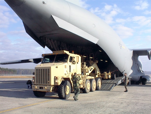 HUNTER ARMY FIELD, Ga. -- An Air Force loadmaster from the 437th Airlift Wing at Charleston Air Force Base, S.C., directs the loading of an M1070 Heavy Equipment Transporter onto a C-17 Globemaster III here.  The trailer is used to move Army M1 Abrams tanks.  The exercise was part of a joint training program established by Maj. Edward Black, an Air Mobility Liaison Officer with the 3rd Infantry Division, to provide more realistic load training for the Air Force and more airlift equipment preparation training for the Army.  (Courtesy photo)
