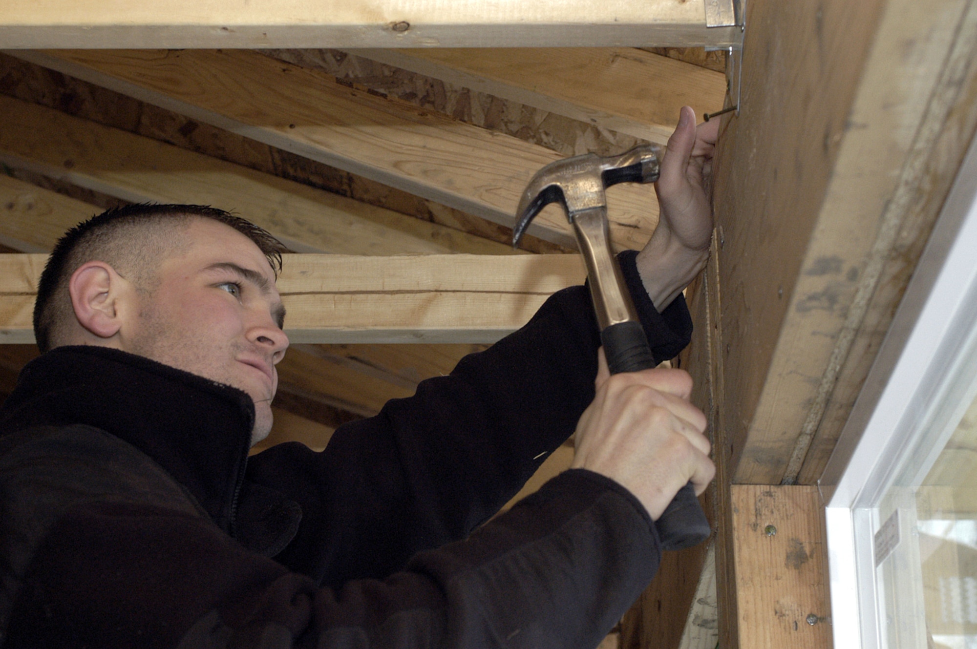 OGDEN, Utah -- Airman 1st Class Brent Contratto nails a beam brace on a new Habitat for Humanity house airmen from nearby Hill Air Force Base are building.  Airman Contratto is a line delivery crew chief with the 388th Equipment Maintenance Squadron.  (U.S. Air Force photo by Senior Airman Nakita Carlisle)