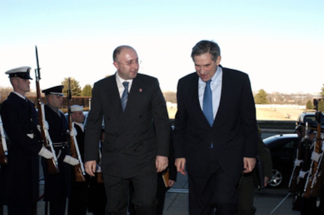 Deputy Secretary of Defense Paul Wolfowitz (right) escorts Minister of Defense of Georgia Gela Bezhuashvili through a cordon and into the Pentagon on Feb. 25, 2004. The two leaders are meeting to discuss defense issues of mutual interest. 