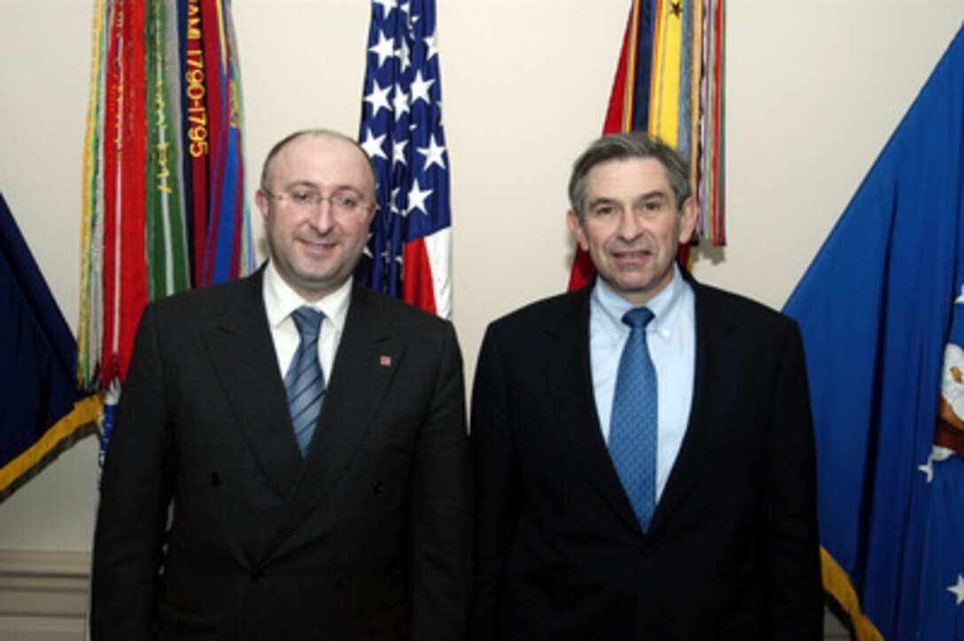 Minister of Defense of Georgia Gela Bezhuashvilii (left) and Deputy Secretary of Defense Paul Wolfowitz pose for photographs prior to their Pentagon meeting on Feb. 25, 2004. The two leaders are meeting to discuss defense issues of mutual interest. 