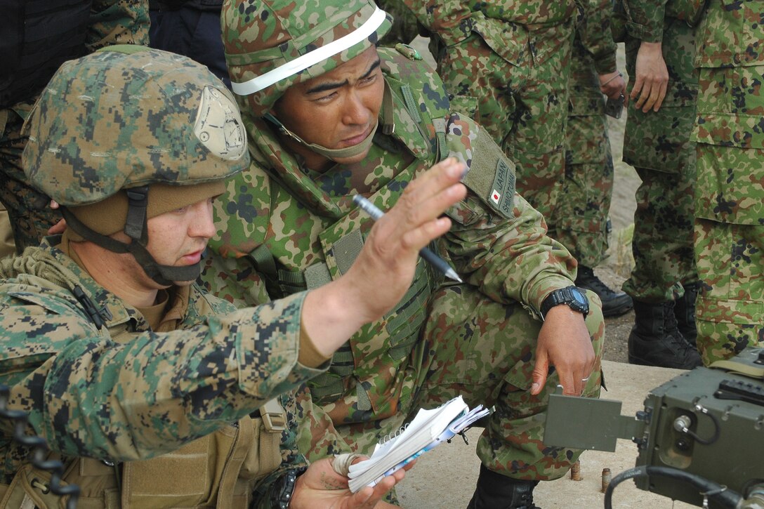 Cpl. Robert T. Ruiz, fire support man, 1st Air Naval Gunfire Liaison Company, reviews notes with a forward observer of the Japanese Ground Self Defense Force during a live-fire exercise at San Clemente Island, Feb. 12. The training event was part of Exercise Iron Fist 2012, a bilateral training exercise between the 15th Marine Expeditionary Unit and the Japanese Ground Self Defense Force.
