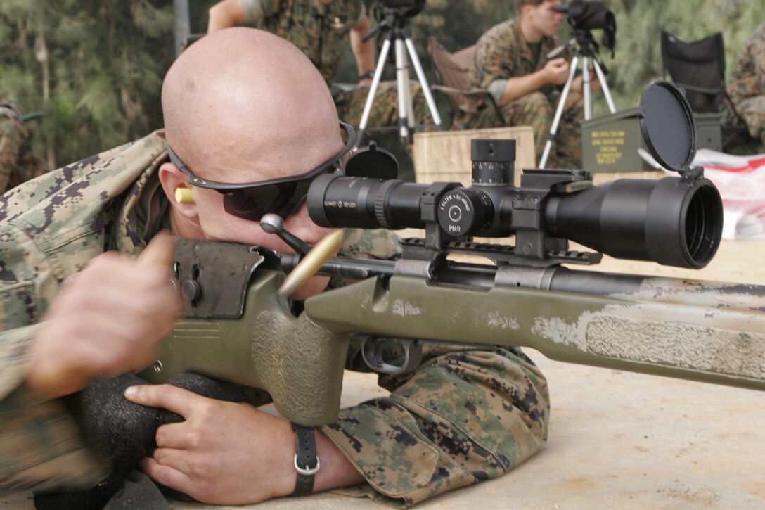 Cpl. Mikhail H. Schmidt, a scout sniper with 1st Platoon, Bravo Company, 3rd Marine Division, ejects a round after firing on a target during the Urban Sniper Course May 18 at Range 18. During the course Marines  fired to improve their combat skills in urban environments.