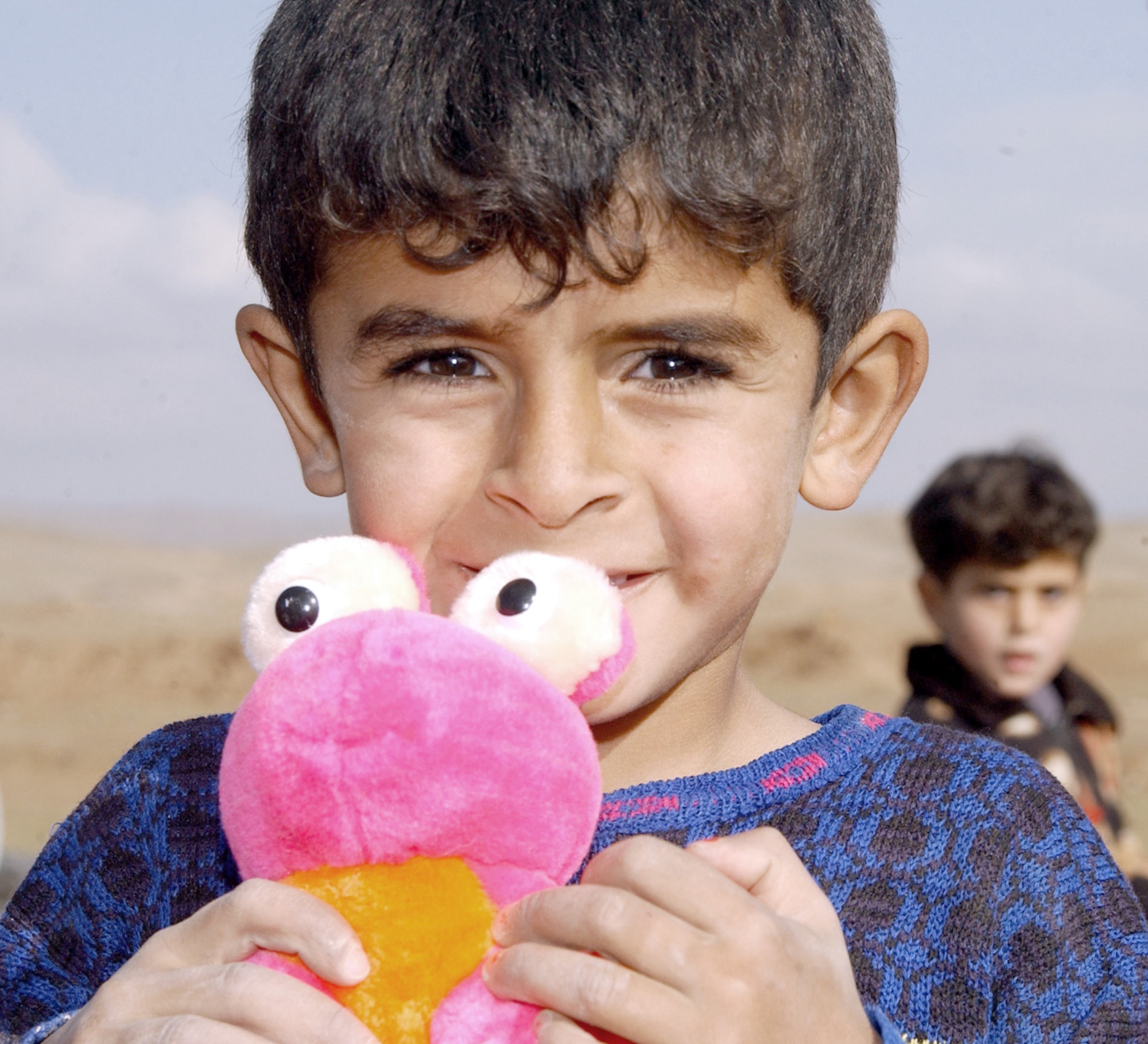 KIRKUK, Iraq -- A child clutches the toy that was given to him during a chapel-sponsored visit to a local village.  Airmen and soldiers delivered several loads of donated boxed goods to the village sent from the United States.  (U.S. Air Force photo by Airman 1st Class Alicia Sarkkinen)