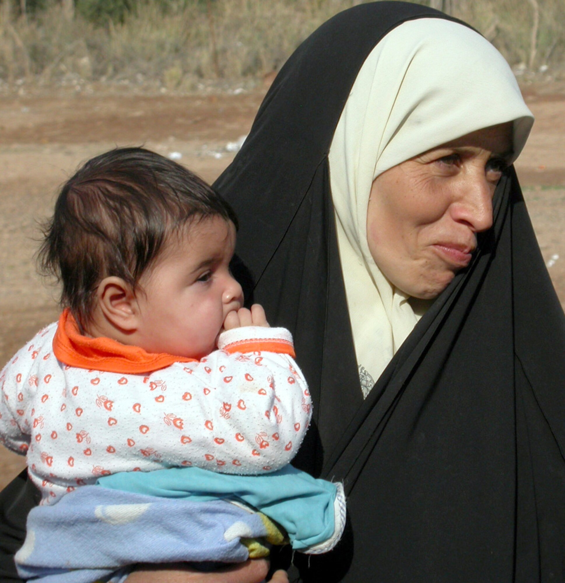 ALBU ASSAD, Iraq -- A village woman waits patiently outside the school house for her child to receive an examination during a medical civil action program visit here by airmen and soldiers.  Air Force physicians and technicians joined an Army medical team to provide care to local residents Jan. 4.  (U.S. Air Force photo by Staff Sgt. A.C. Eggman)